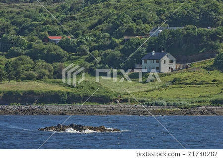 People enjoying living in beautiful landscape full of rock formations along the irish coastline near Killybegs, County Donegal in Ireland People enjoying living in beautiful landscape full of rock formations along the irish coastline near Killybegs, County Donegal in Ireland 71730282