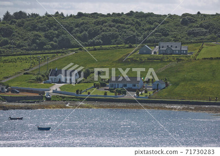 People enjoying living in beautiful landscape full of rock formations along the irish coastline near Killybegs, County Donegal in Ireland People enjoying living in beautiful landscape full of rock formations along the irish coastline near Killybegs, County Donegal in Ireland 71730283