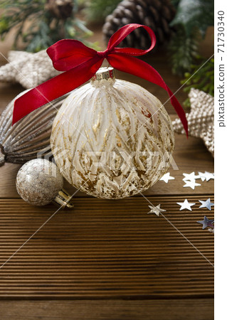 Christmas background, mock up. Bauble with red bow and winter decoration, wooden background with copy space. Christmas background, mock up. Bauble with red bow and winter decoration, wooden background with copy space. 71730340