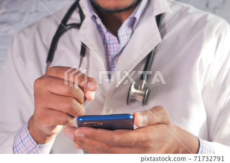 Close up of doctor hand using smartphone in the hospital. Close up of doctor hand using smartphone in the hospital. 71732791