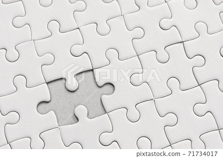 White jigsaw puzzle pattern background. placing last piece of jigsaw puzzle. White jigsaw puzzle pattern background. placing last piece of jigsaw puzzle. 71734017