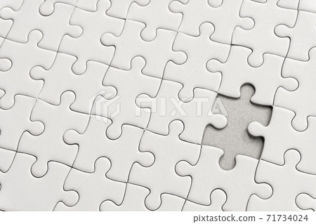 White jigsaw puzzle pattern background. placing last piece of jigsaw puzzle. White jigsaw puzzle pattern background. placing last piece of jigsaw puzzle. 71734024
