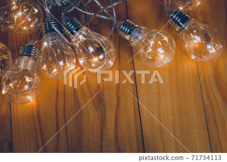 Light bulbs over wooden background 71734113