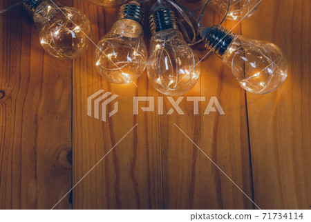 Light bulbs over wooden background 71734114