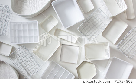 Flat lay of Marie Kondo's white storage boxes, containers and baskets with different sizes and shapes Flat lay of Marie Kondo's white storage boxes, containers and baskets with different sizes and shapes 71734805