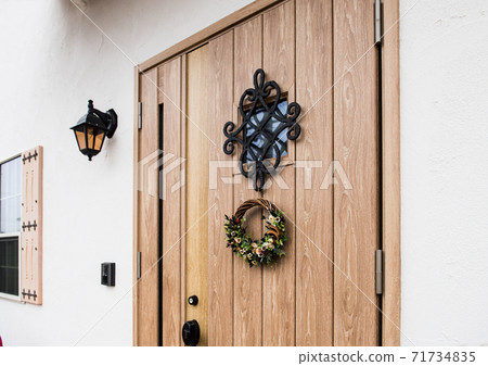 Newly built detached house entrance door Christmas wreath 71734835