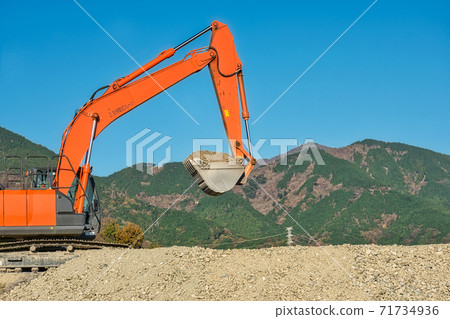 Heavy machinery transporting waste soil in the mountains 71734936
