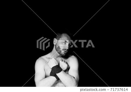A man with his hands tied on a dark background, domination, suppression of will and lack of freedom A man with his hands tied on a dark background, domination, suppression of will and lack of freedom 71737614