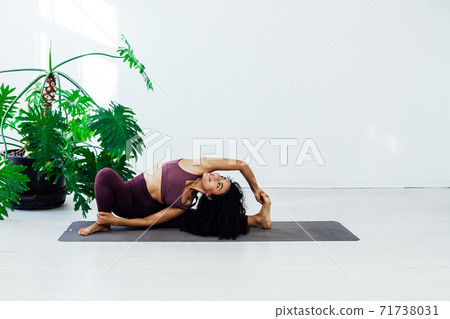 Beautiful brunette woman engaged in yoga sports fitness asana body flexibility 71738031