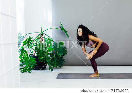 Female brunette engaged in yoga fitness asana body flexibility 71738033