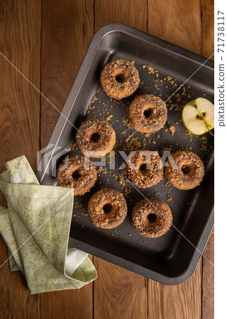 Apple cider donuts on baking tray with napkin Apple cider donuts on baking tray with napkin 71738117