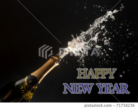 Happy new year theme with splashing champagne Happy new year theme with splashing champagne 71738236