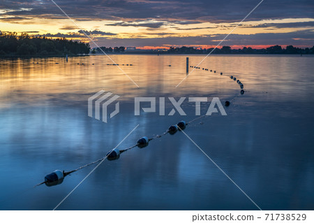 lake swimming beach at dawn 71738529