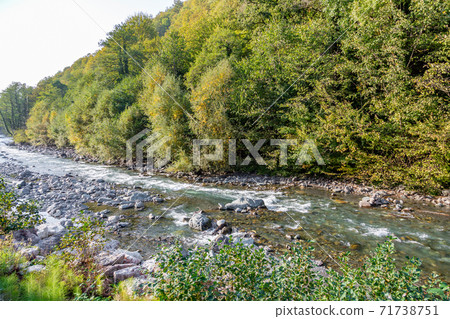Turbulent flow of a mountain river in the daytime 71738751