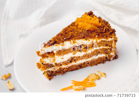 Carrot cake with walnuts. Piece of Cake on a Plate. Sweet food. Sweet dessert. White background. Carrot cake with walnuts. Piece of Cake on a Plate. Sweet food. Sweet dessert. White background. 71739715