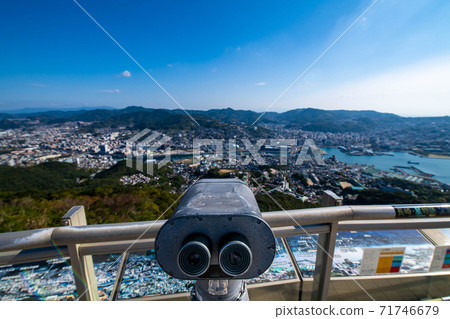 Binocular telescope at the summit observatory of Mt. Inasa, Nagasaki in fine weather Binocular telescope at the summit observatory of Mt. Inasa, Nagasaki in fine weather 71746679