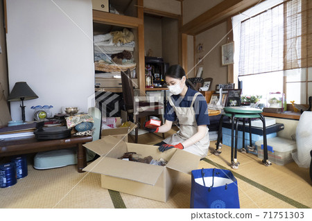 Female worker cleaning up a messy room 71751303