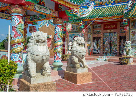San Chao Pho Ongkharak Tutelary Shrine and The statue of Stone lion in front of the Shrine, focus selective. 71751733