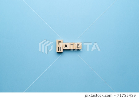 The concept of hate and fate. Letters on a blue background. 71753459