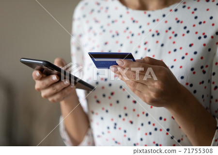 Close up of woman make payment online with credit card Close up of woman make payment online with credit card 71755308