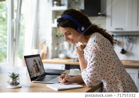 Smiling woman talk on video call studying Smiling woman talk on video call studying 71755332