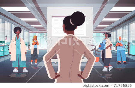 team of mix race doctors in uniform discussing during meeting in hospital corridor medicine healthcare team of mix race doctors in uniform discussing during meeting in hospital corridor medicine healthcare 71756836