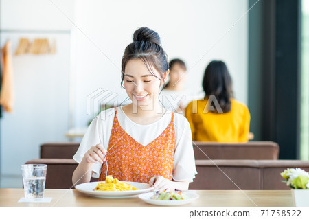 Young woman eating lunch at a restaurant Young woman eating lunch at a restaurant 71758522