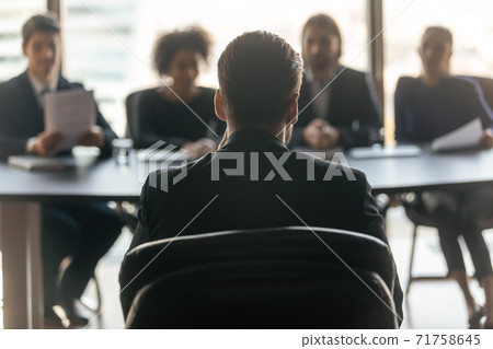 Back view of male applicant have interview with employers Back view of male applicant have interview with employers 71758645
