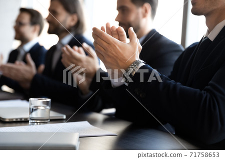 Close up of businessmen applaud at office meeting Close up of businessmen applaud at office meeting 71758653