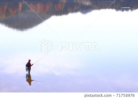 Fisherman on the lake 71758976