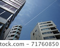 3 buildings and contrails on a sunny day 71760850