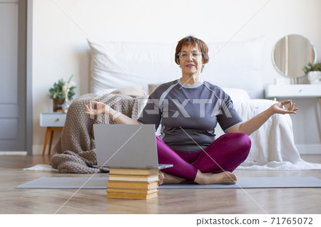 Senior woman meditating. Senior woman meditating. 71765072