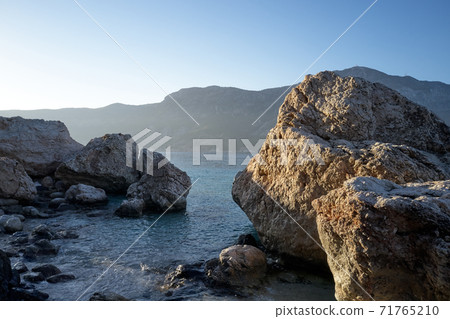 Beautiful rocky cliffs and clear ocean water. 71765210