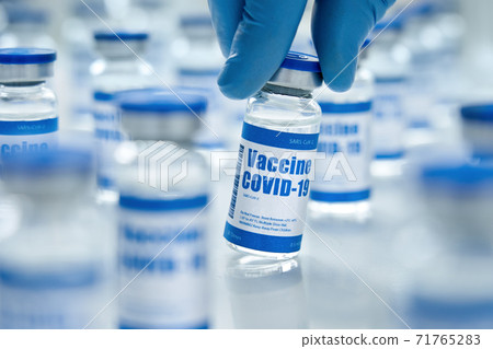 Covid 19 vaccine vial bottles, corona virus cure manufacture concept. Covid 19 vaccine vial bottles, corona virus cure manufacture concept. 71765283