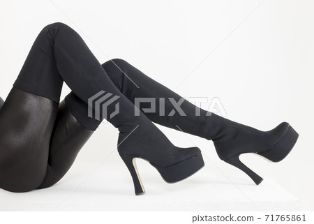 Black women's boots on white background 71765861