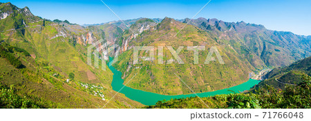 Ha Giang karst geopark mountain landscape in North Vietnam. Winding road in stunning scenery. Ha Giang motorbike loop, famous travel destination bikers easy riders. Ha Giang karst geopark mountain landscape in North Vietnam. Winding road in stunning scenery. Ha Giang motorbike loop, famous travel destination bikers easy riders. 71766048