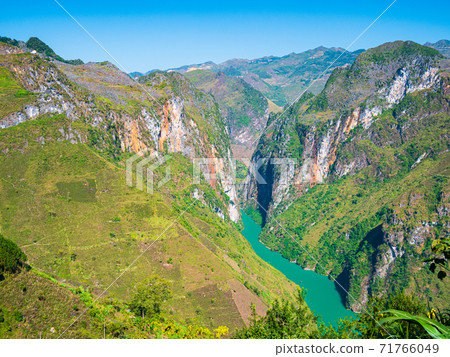 Ha Giang karst geopark mountain landscape in North Vietnam. Winding road in stunning scenery. Ha Giang motorbike loop, famous travel destination bikers easy riders. Ha Giang karst geopark mountain landscape in North Vietnam. Winding road in stunning scenery. Ha Giang motorbike loop, famous travel destination bikers easy riders. 71766049