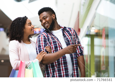 Beautiful black couple enjoying shopping together in modern department store Beautiful black couple enjoying shopping together in modern department store 71766581
