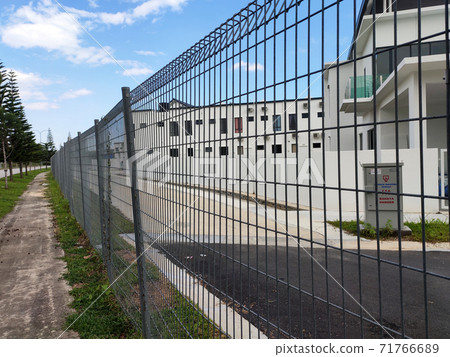 MELAKA, MALAYSIA -JUNE 5, 2020: Anti-climb fencing made from galvanized iron install at the perimeter or property boundary to prevent from the intruder. Its close nets can prevent intruders from climb 71766689