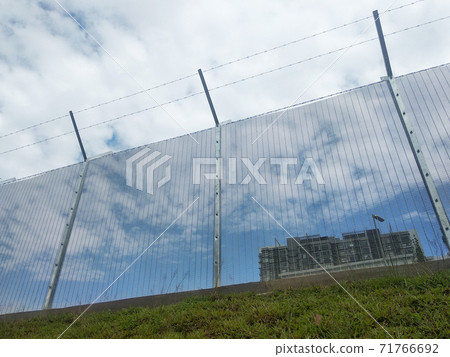 MELAKA, MALAYSIA -JUNE 5, 2020: Anti-climb fencing made from galvanized iron install at the perimeter or property boundary to prevent from the intruder. Its close nets can prevent intruders from climb MELAKA, MALAYSIA -JUNE 5, 2020: Anti-climb fencing made from galvanized iron install at the perimeter or property boundary to prevent from the intruder. Its close nets can prevent intruders from climb 71766692