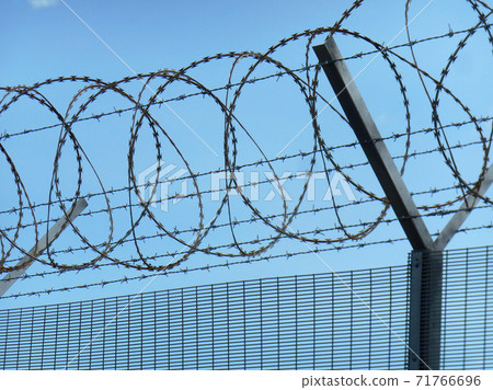 MELAKA, MALAYSIA -JUNE 5, 2020: Anti-climb fencing made from galvanized iron install at the perimeter or property boundary to prevent from the intruder. Its close nets can prevent intruders from climb MELAKA, MALAYSIA -JUNE 5, 2020: Anti-climb fencing made from galvanized iron install at the perimeter or property boundary to prevent from the intruder. Its close nets can prevent intruders from climb 71766696
