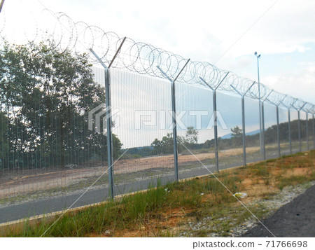 MELAKA, MALAYSIA -JUNE 5, 2020: Anti-climb fencing made from galvanized iron install at the perimeter or property boundary to prevent from the intruder. Its close nets can prevent intruders from climb 71766698