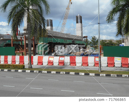 KUALA LUMPUR, MALAYSIA -JUNE 27, 2020: Plastic jersey barrier is a modular barrier that is temporarily used to reroute traffic and protect pedestrians while construction is underway.  71766865