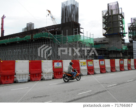 KUALA LUMPUR, MALAYSIA -JUNE 27, 2020: Plastic jersey barrier is a modular barrier that is temporarily used to reroute traffic and protect pedestrians while construction is underway. KUALA LUMPUR, MALAYSIA -JUNE 27, 2020: Plastic jersey barrier is a modular barrier that is temporarily used to reroute traffic and protect pedestrians while construction is underway. 71766867