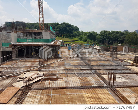 KUALA LUMPUR, MALAYSIA -NOVEMBER 21, 2020: Building floor slab under construction. Construction workers fabricating the timber formwork and installing the steel reinforcement bar.  71767497