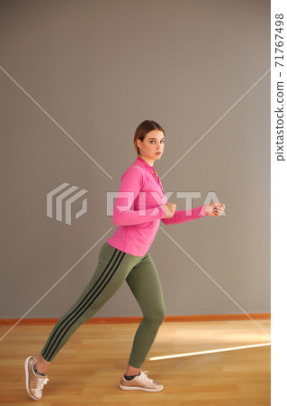 Side view of active sporty young running woman runner athlete with copy space concept sport health fitness loss weight cardio training jog workout wellness. Side view of active sporty young running woman runner athlete with copy space concept sport health fitness loss weight cardio training jog workout wellness. 71767498
