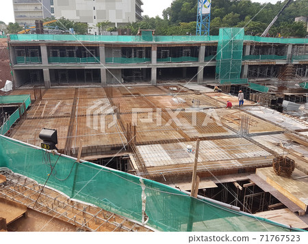 KUALA LUMPUR, MALAYSIA -NOVEMBER 21, 2020: Building floor slab under construction. Construction workers fabricating the timber formwork and installing the steel reinforcement bar. KUALA LUMPUR, MALAYSIA -NOVEMBER 21, 2020: Building floor slab under construction. Construction workers fabricating the timber formwork and installing the steel reinforcement bar. 71767523