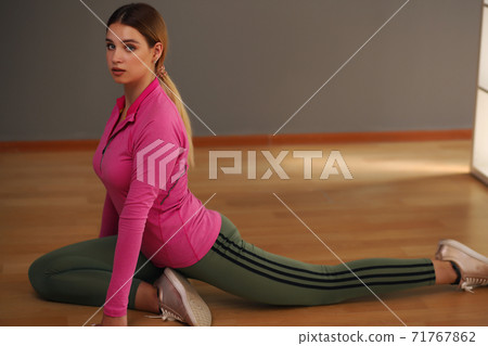 Beautiful teenage girl in sportswear, yoga position in a health club Beautiful teenage girl in sportswear, yoga position in a health club 71767862