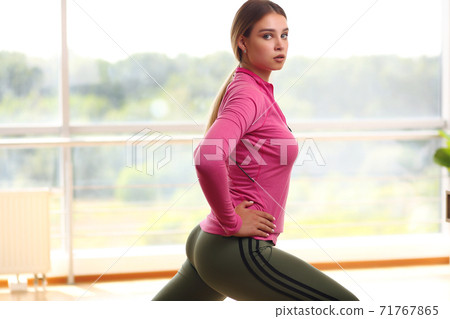 Image of beautiful young sporty blonde woman doing fitness exercises 71767865