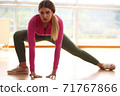 Young sport happy sexy blonde girl in green leggings and pink top doing yoga exercise 71767866
